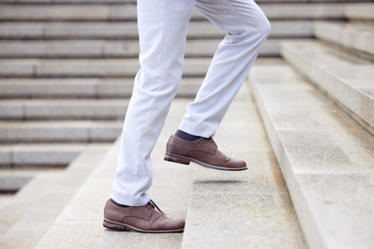 Person taking the stairs symbolizing taking steps to successful resolutions.